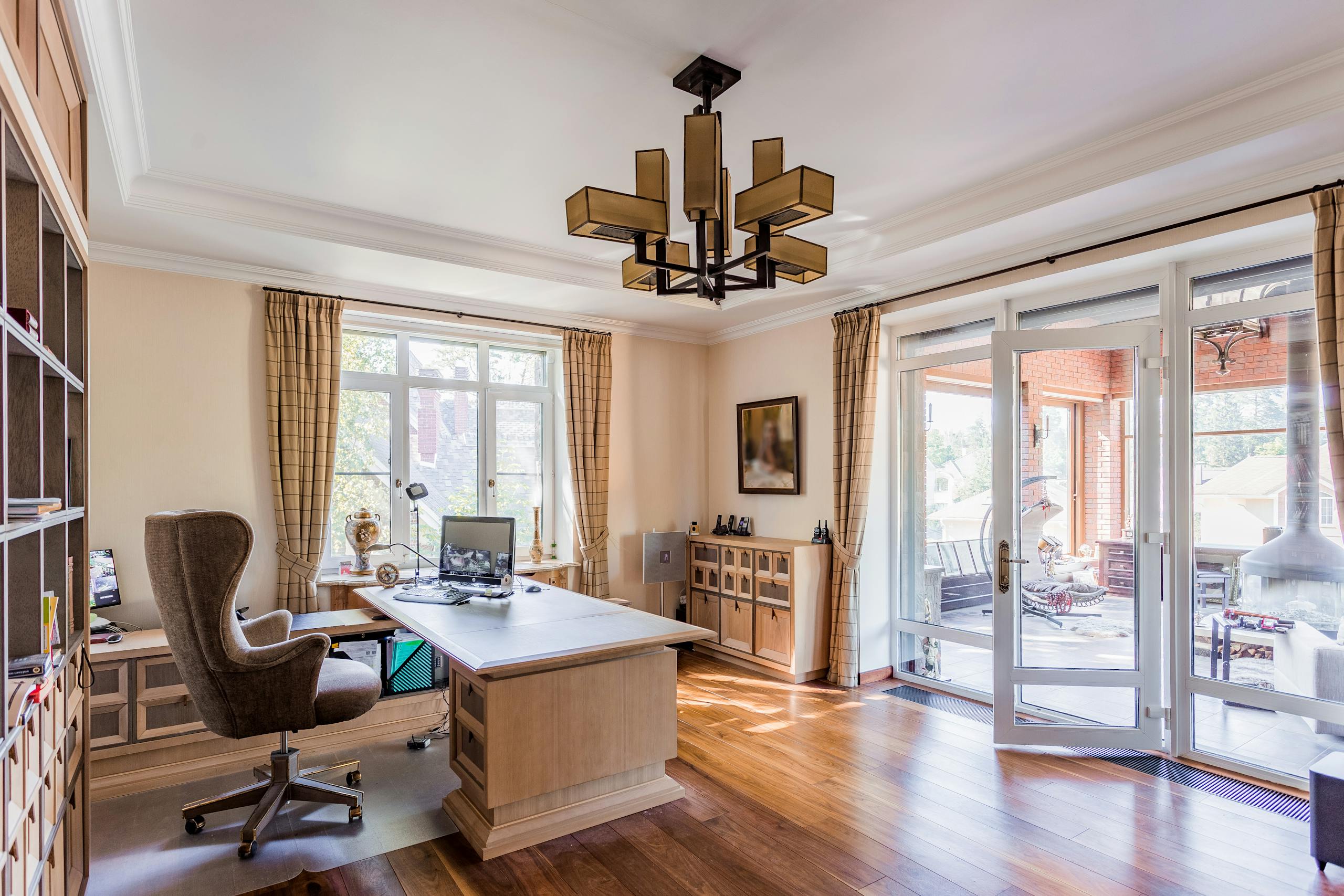 Spacious home office with modern decor and ample natural lighting, ideal for productivity.